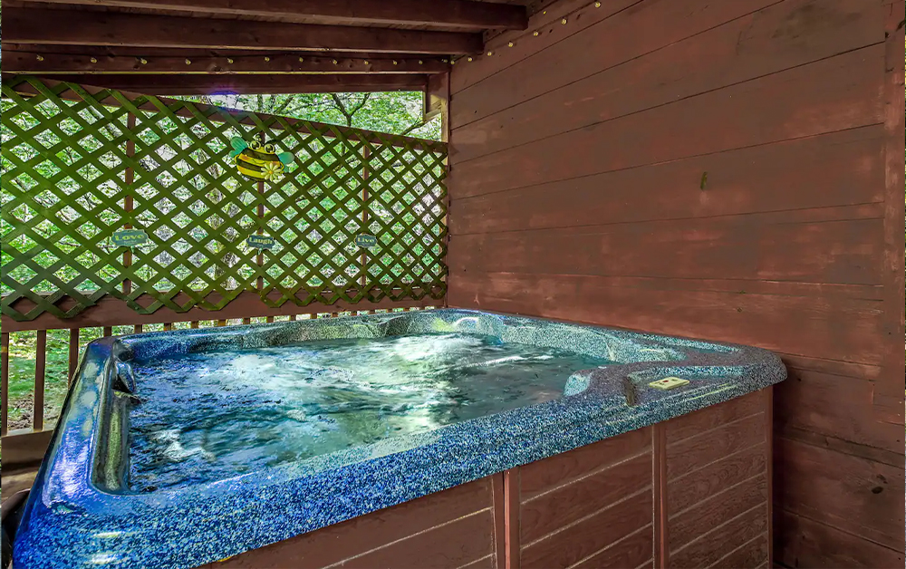 A large indoor jetted tub set in a cozy wood-paneled room, a key feature for a Romantic Getaway With Hot Tub.