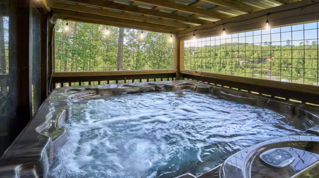 Outdoor hot tub with forest views at Gatlinburg TN vacation rentals.